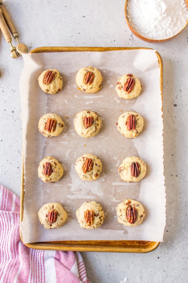 adding pecans to snowball cookie