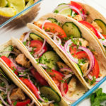 tomatoes and cucumbers on chicken tacos