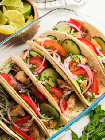 tomatoes and cucumbers on chicken tacos