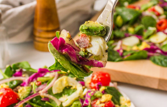 a bite of spinach cobb salad