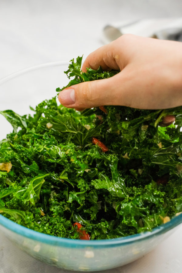 massaging kale with hands
