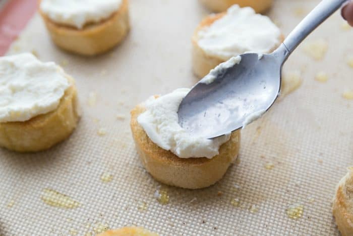 Ricotta Lemon Basil Honey Bruschetta - spreading ricotta