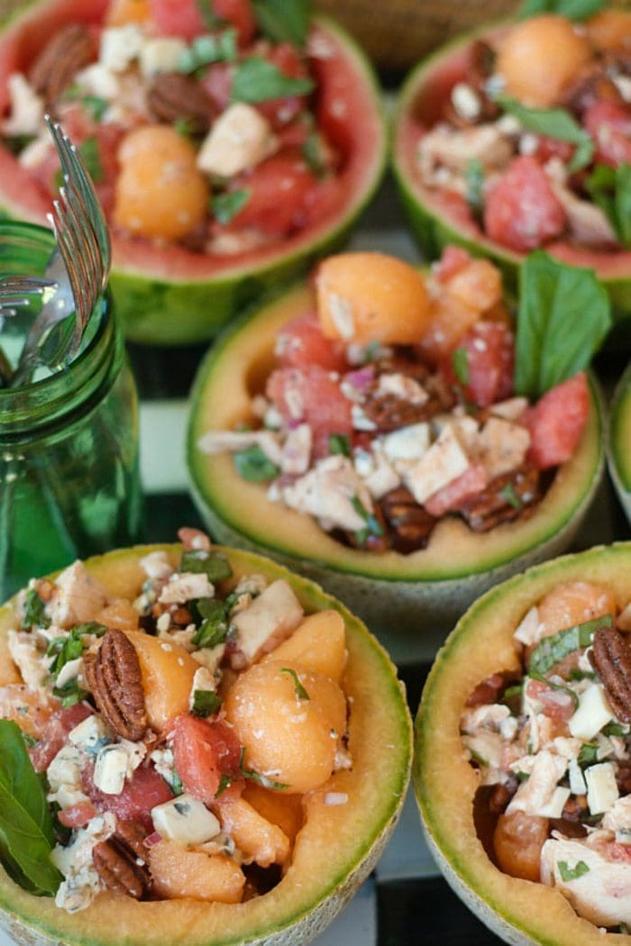 melons cut in half and filled with melon balls and chicken salad