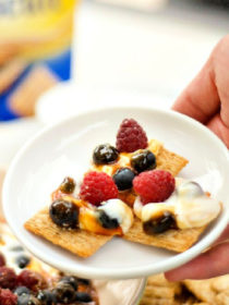 salted caramel yogurt dip on salty crackers with fresh berries