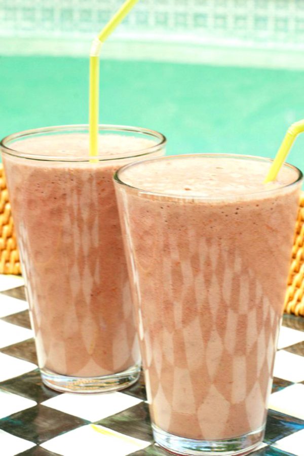 2 glasses of raspberry smoothies with yellow straws
