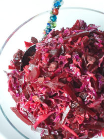 clear bowl of Red Cabbage Beet Slaw with Cranberries
