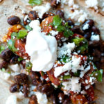 roasted tomatoes on a black bean taco