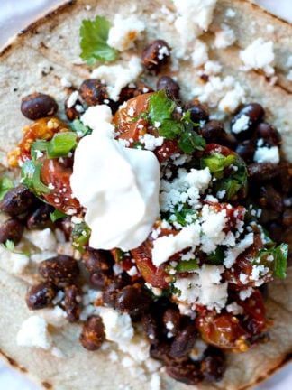 roasted tomatoes on a black bean taco