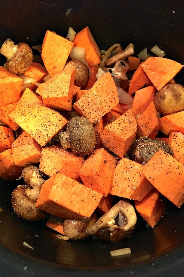making a pot of chicken with sweet potatoes and mushrooms