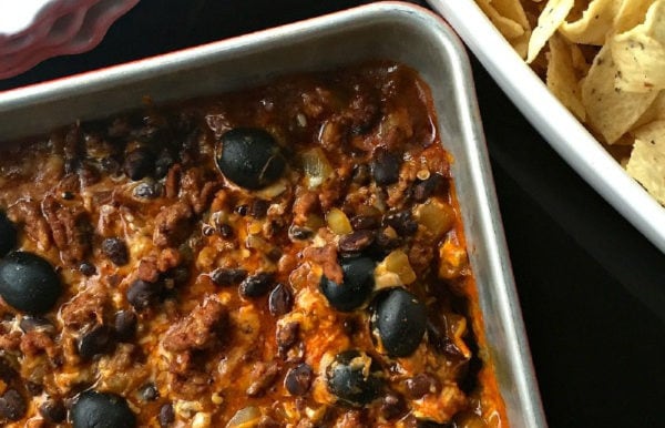 pan of Cheesy Enchilada Dip with olives