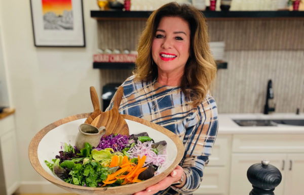 woman holding a large salad bowl