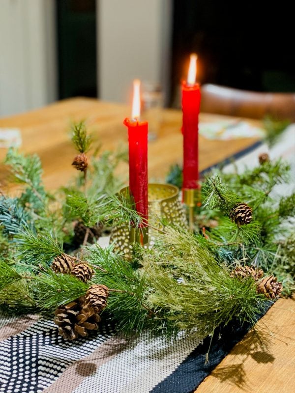 burning 2 red candles with green wreath