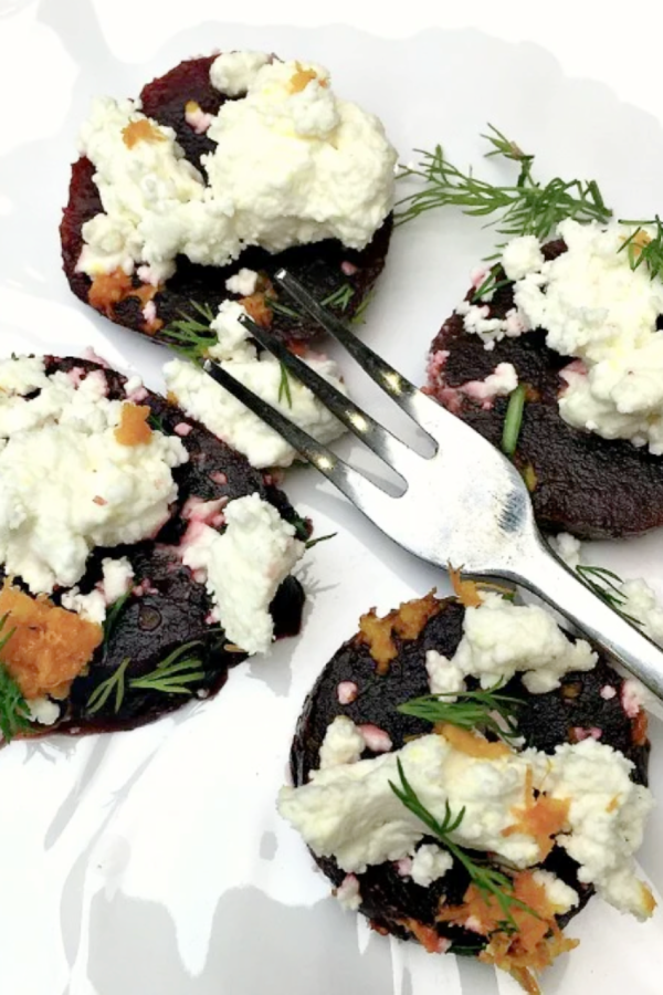 a bite of fresh beet with goat cheese and dill