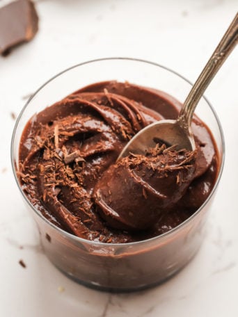 taking a bite of mousse with chocolate shavings