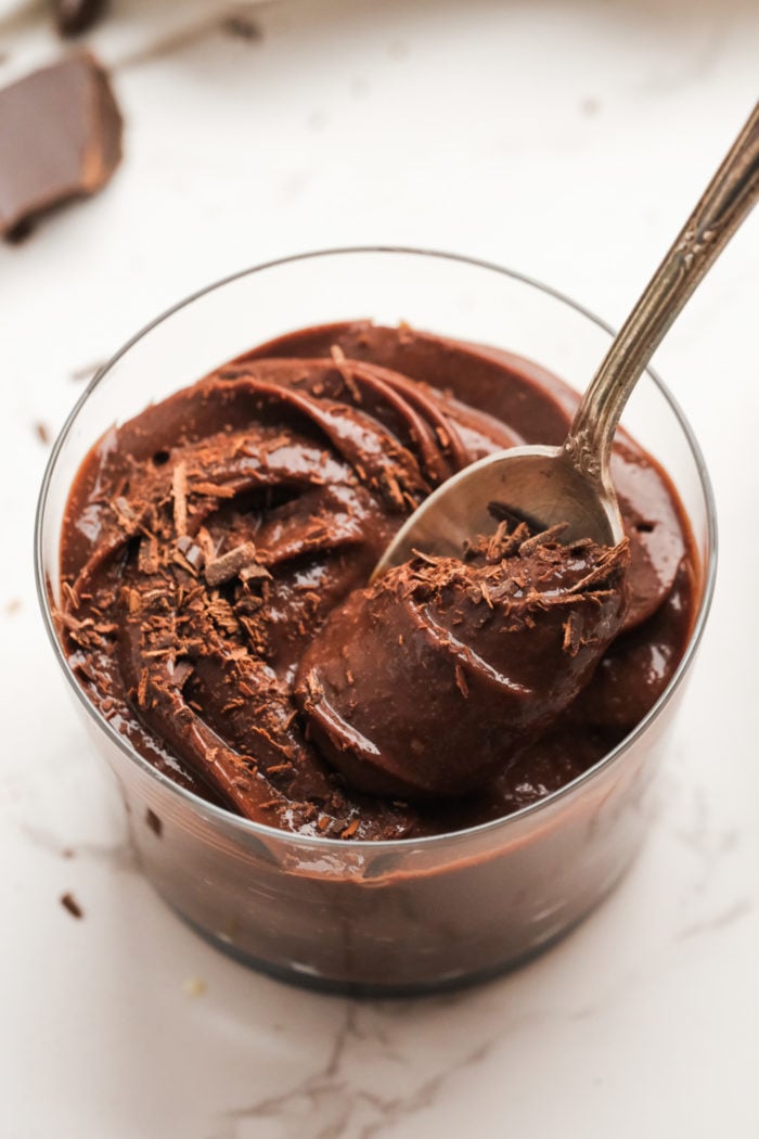 taking a bite of mousse with chocolate shavings