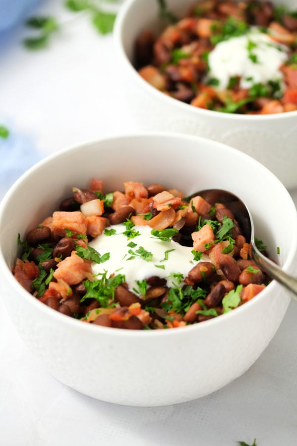 bow of Mexican Charro Beans with Ham with spoon