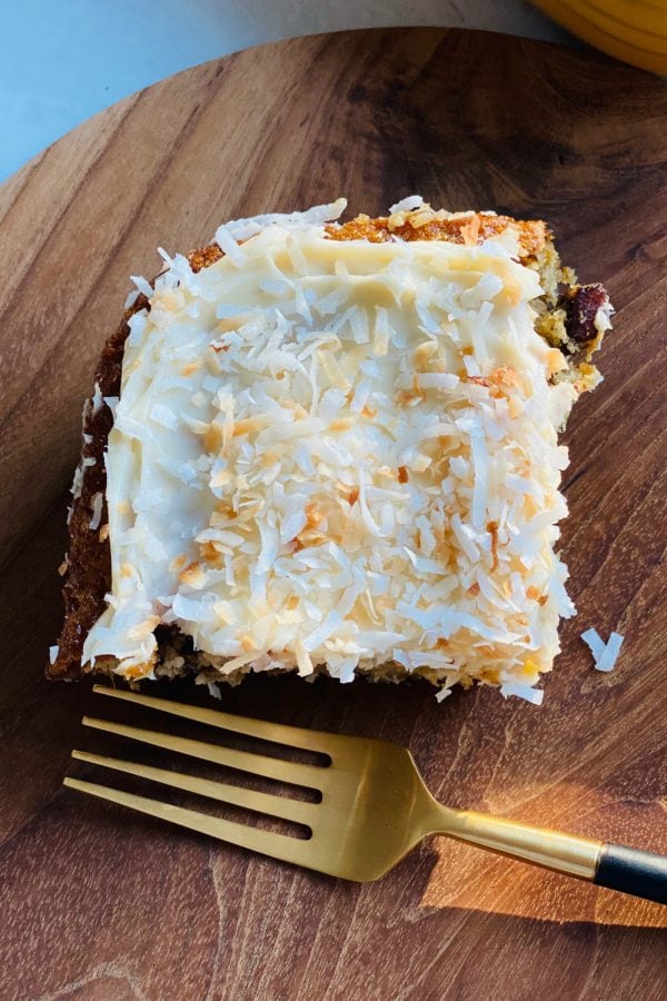 piece of pineapple cake with cream cheese frosting and toasted coconut 