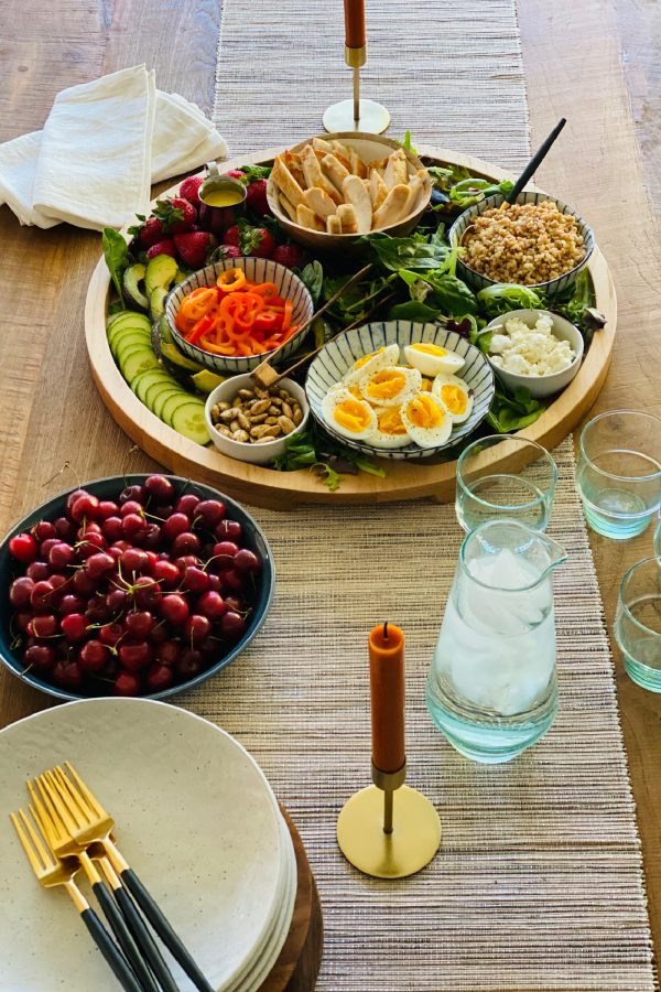 a table set with Chicken Farro Salad board