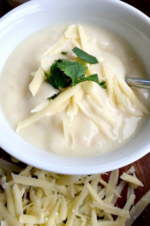 Cauliflower White Cheddar Cheese Soup with melted cheese on top