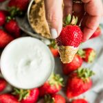 hand dipped strawberry in sour cream and dark brown sugar
