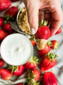 hand dipped strawberry in sour cream and dark brown sugar