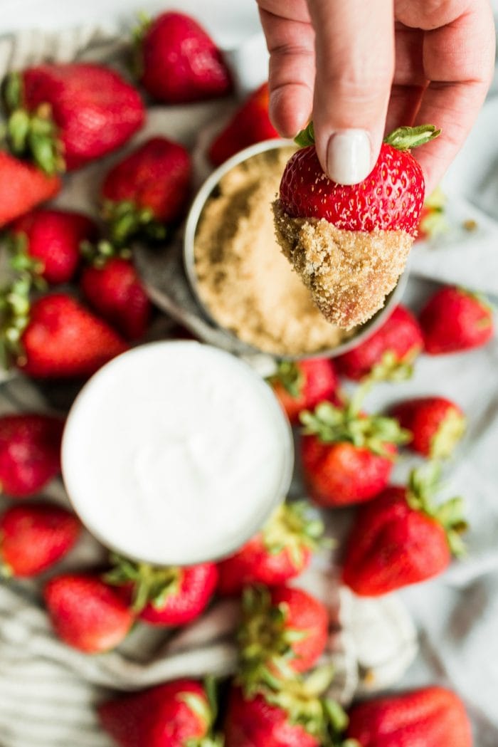 a hand-dipped strawberry with sour cream and brown sugar