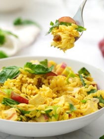 taking a bite of curried orzo salad