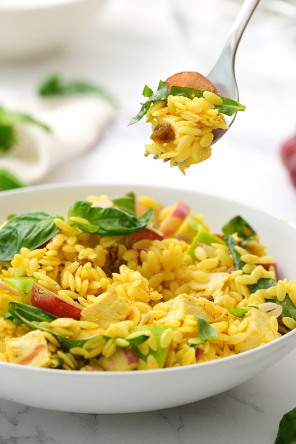 taking a bite of curried orzo salad