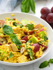 curried orzo salad in a white serving bowl