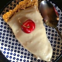 slice of lemonade pie with a cherry on top