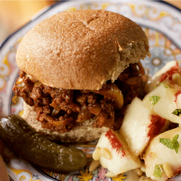 a sloppy joe served with a pickle