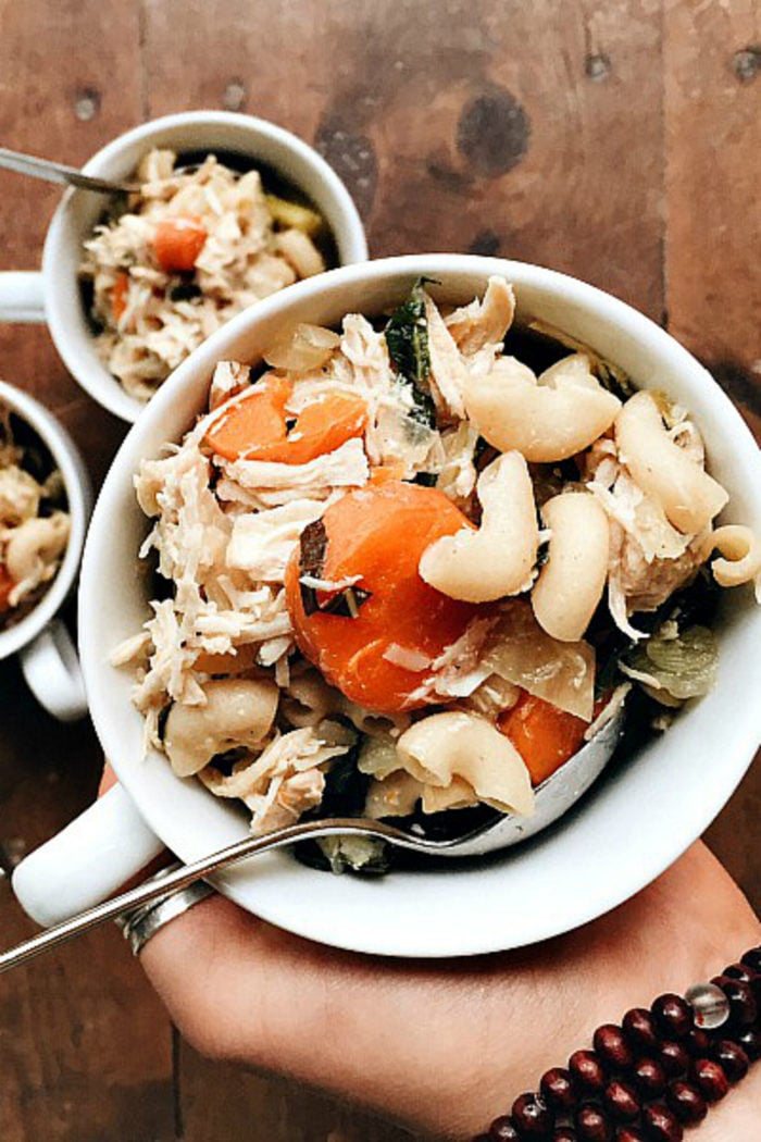 cup of chicken noodle soup with carrots and elbow macaroni