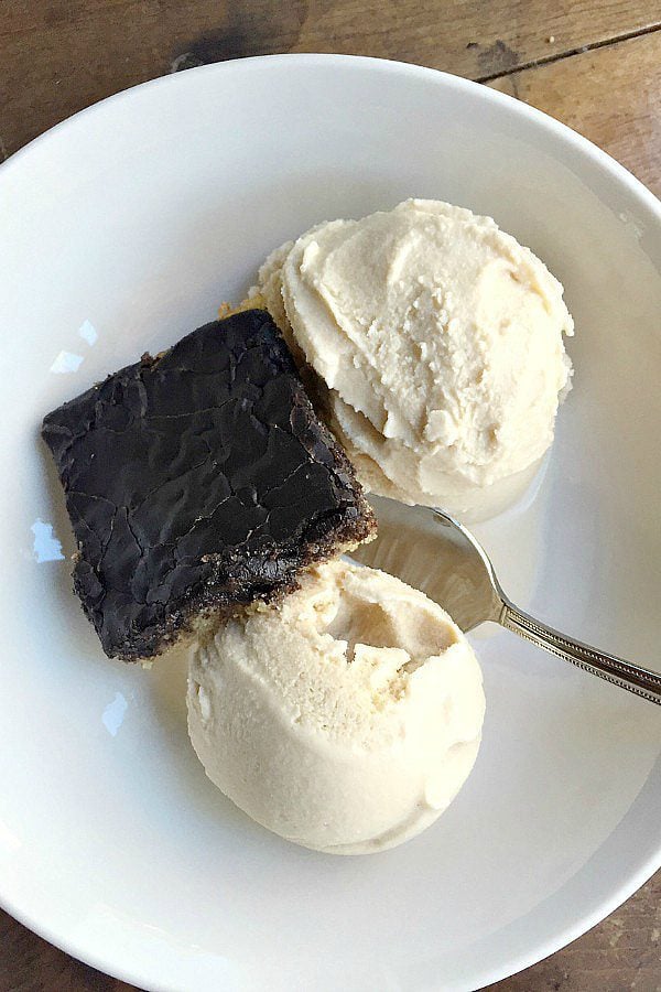 bowl of 2 scoops of vanilla homemade ice cream with brownie