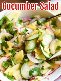 a salad bowl of Pickled Mango Cucumber Salad