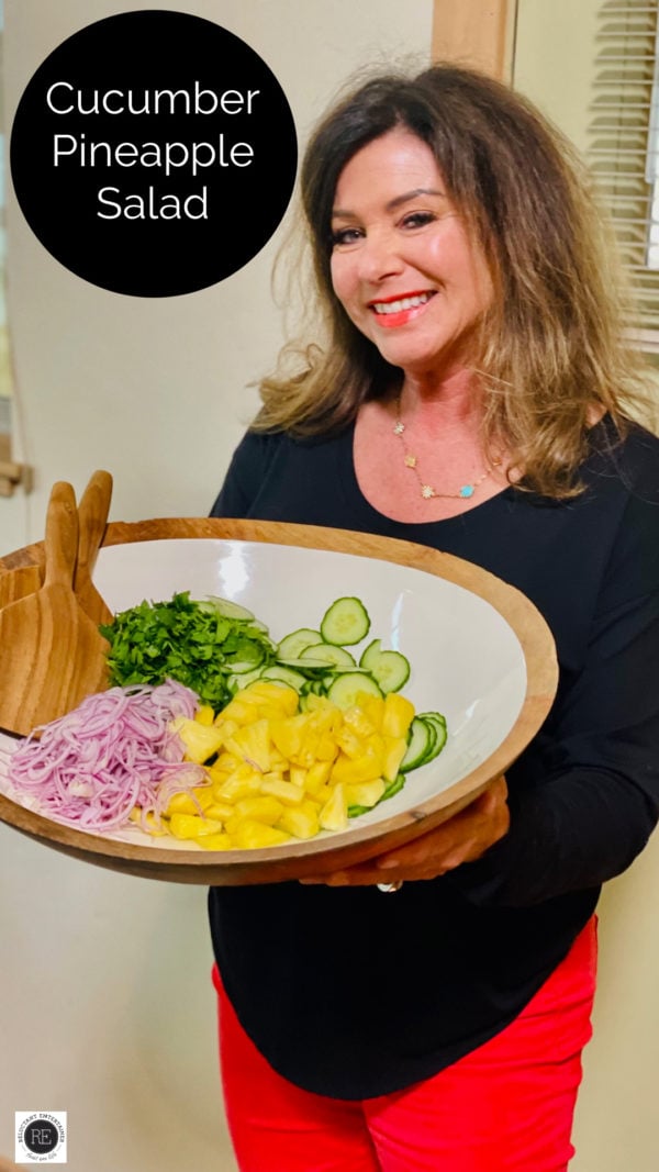 woman holding an epic cucumber salad