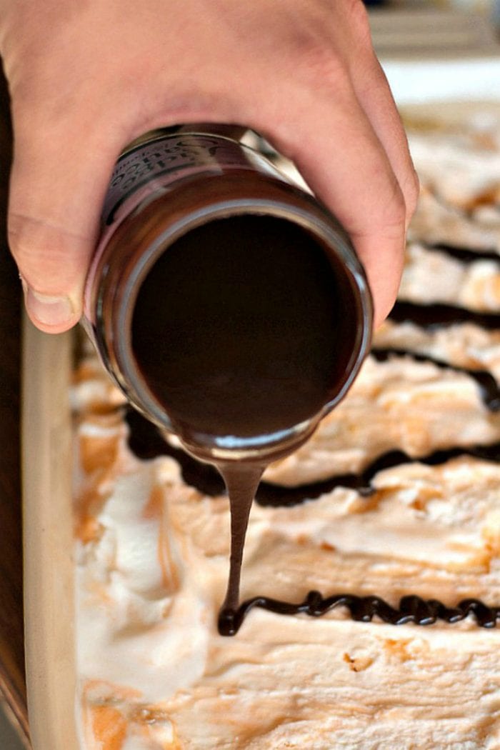 pouring sauce on top of orange creamsicle dessert