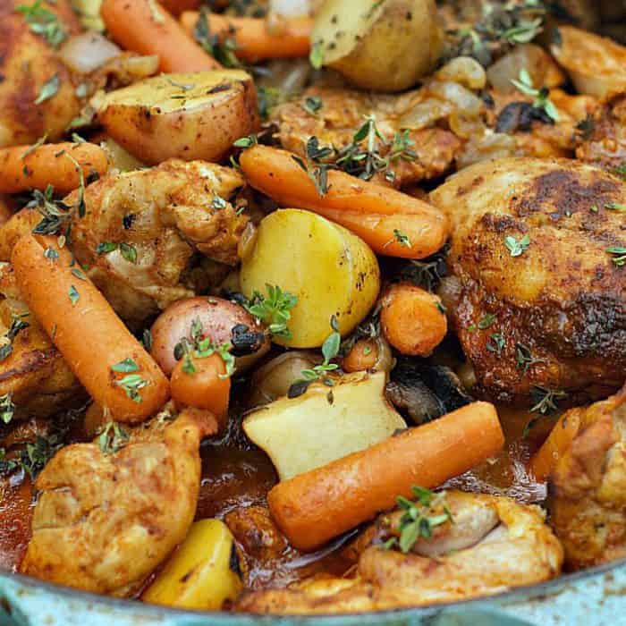 cooked saucy paprika chicken thighs with veggies