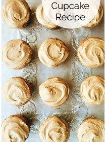 12 zucchini cupcakes on a silver tray with maple frosting