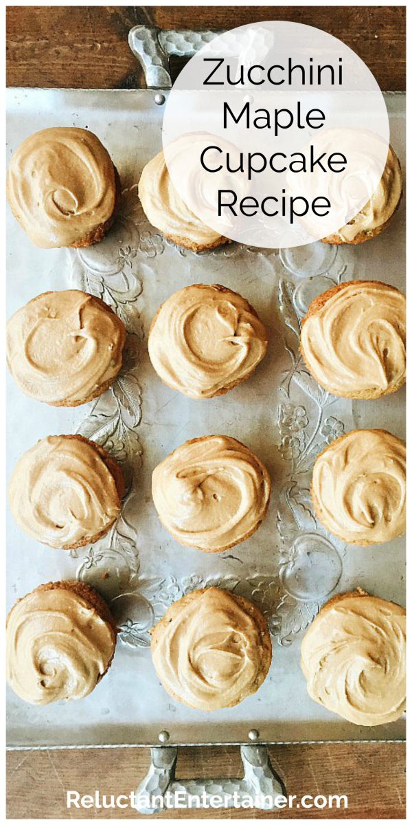 12 zucchini cupcakes on a silver tray with maple frosting