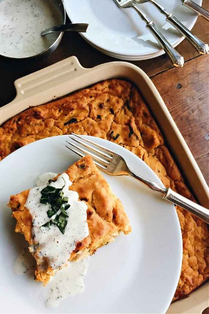 a serving of chicken pumpkin bake with herbed cream sauce in 9x13 dish
