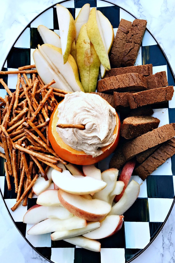 Pumpkin Cream Cheese Dip with snacks on a black and white platter