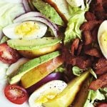 pear salad with sliced avocado, egg, and chopped bacon