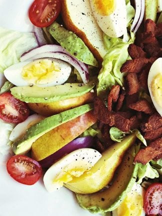 pear salad with sliced avocado, egg, and chopped bacon