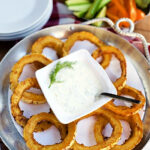 baked squash rounds on a plate with dip