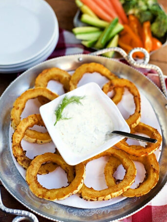 baked squash rounds on a plate with dip
