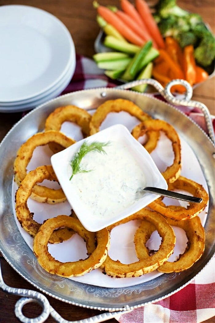 baked squash rounds on a plate with dip