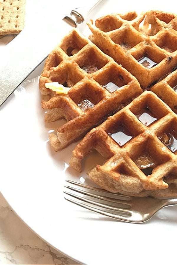 waffles with syrup on a plate with a fork