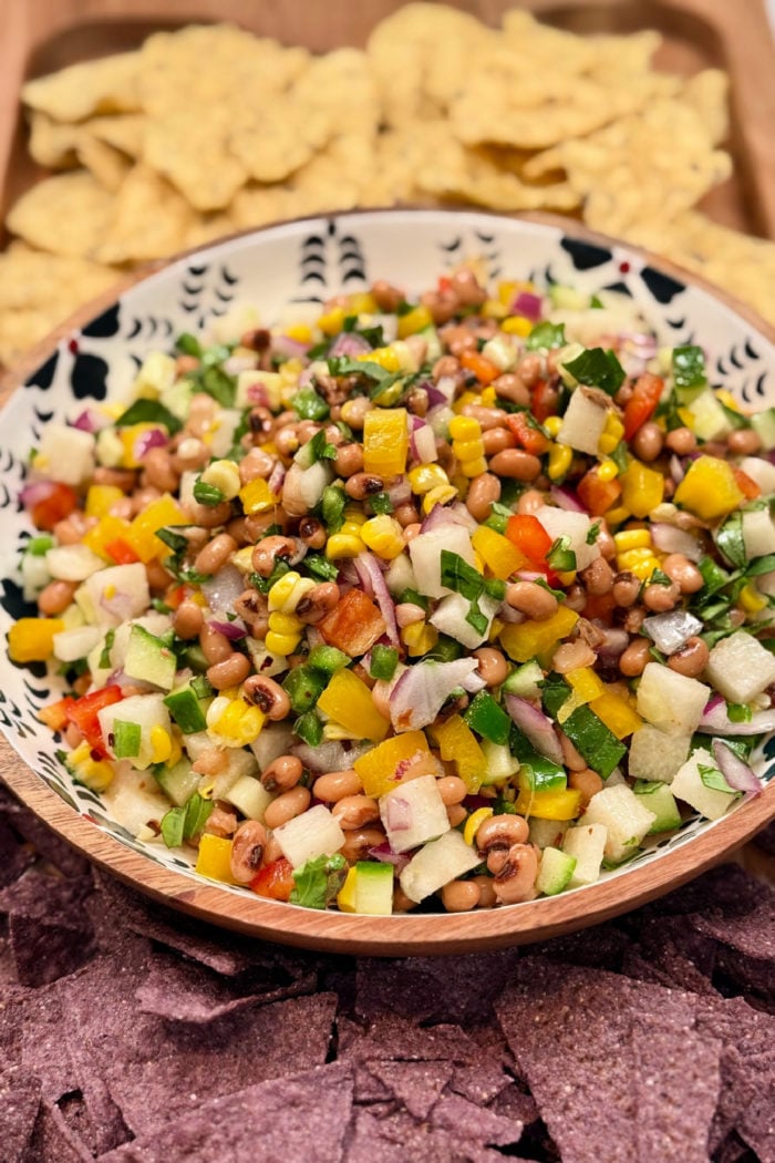 Corn and Black Eyed Pea Salad on board with chips