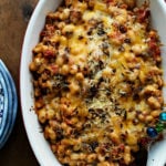 oval dish of baked cheesy Italian baked cannelini beans with rosemary