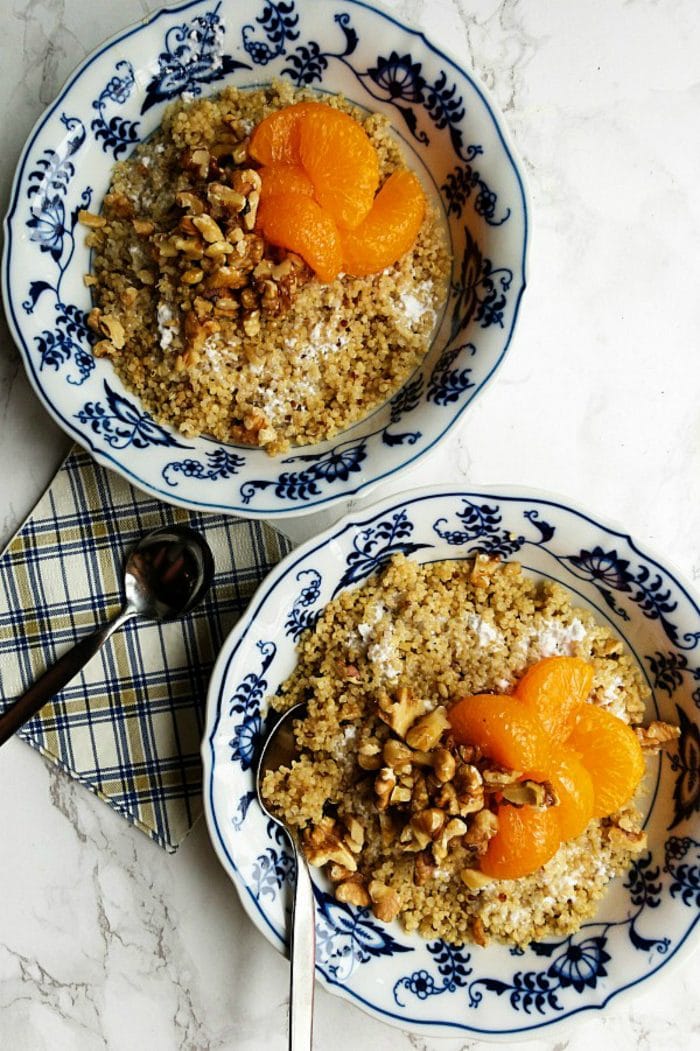 2 quinoa breakfast bowls with mandarin oranges, yogurt, and toasted walnuts